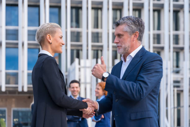 istock Executives Celebrating a Successful Meeting in a Commercial Center 1485063892