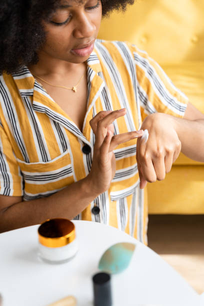 istock Black woman putting moisturizer on her hands 1485063899