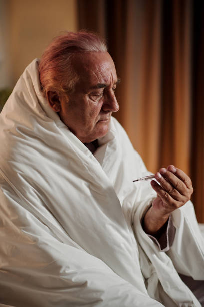 istock Sick Man Measuring Body Temperature 1485063922