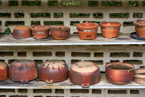 Close-up of charcoal-fired terracotta pot for side stove