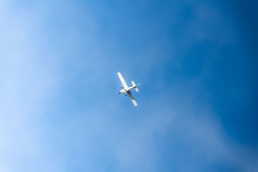 A small aircraft is soaring in the tranquil blue sky.