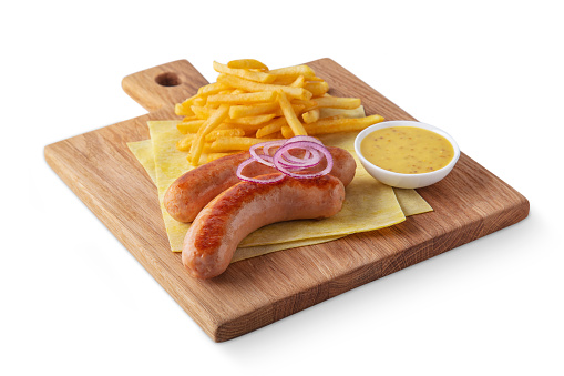 Fried sausages with french fries, onions, lavash and sauce lying on a board on a white background