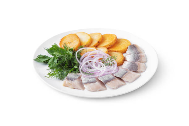 istock Herring with onions, fried potatoes, dill and parsley on a plate and on a white background 1485071307