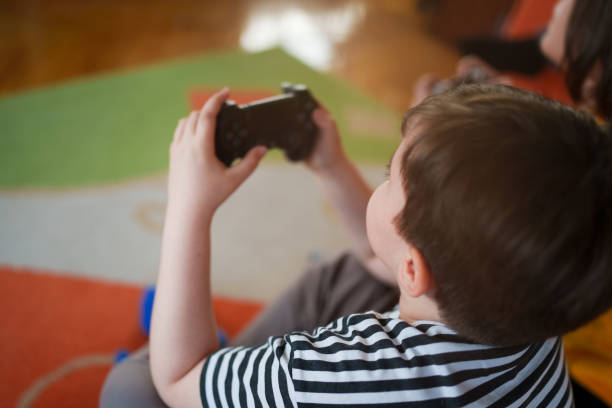 istock 2 boys playing video games in living room 1485077851