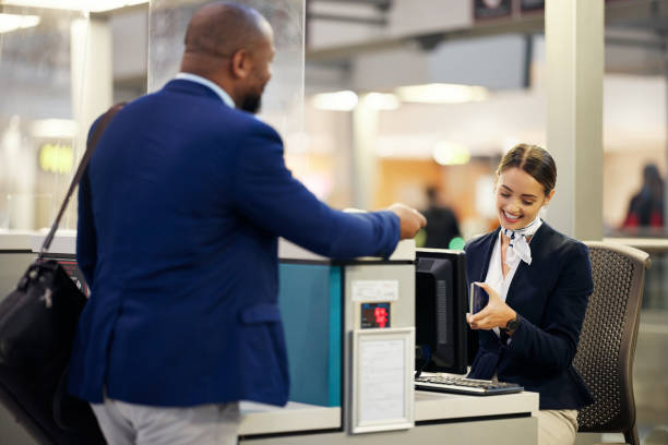 istock Businessman, airport and passenger assistant checking passport documents for check in at terminal counter. Black male traveler and service agent in travel security or immigration for airline control 1485082581