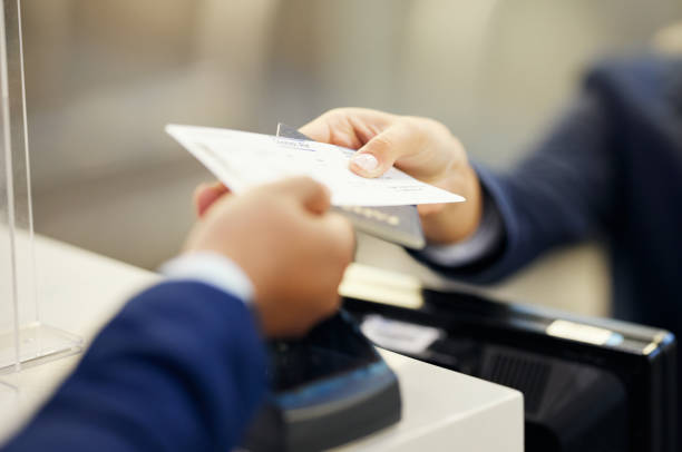 istock Hands, airport and service agent with ticket, passport or documents to board plane at terminal counter. Hand of female passenger assistant giving access for travel, security or immigration papers 1485082665