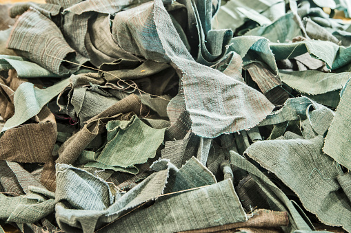Pile of fabric scraps closeup as textile background