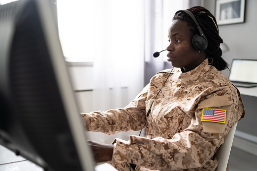 Woman soldier working at military office