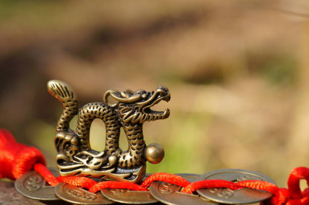 istock Dragon figurine and Chinese coins. A religious symbol. 1485086795
