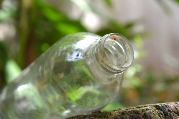 closeup clear glass bottle isolated on blurred background