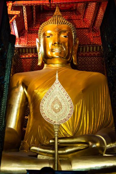 istock Golden statuette of Buddha in a peaceful pose inside a temple 1485088356