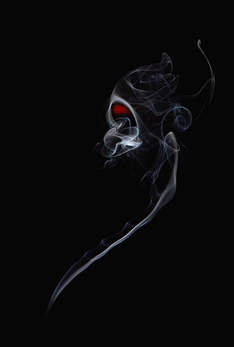 A vertical shot of smoke rising against a black background