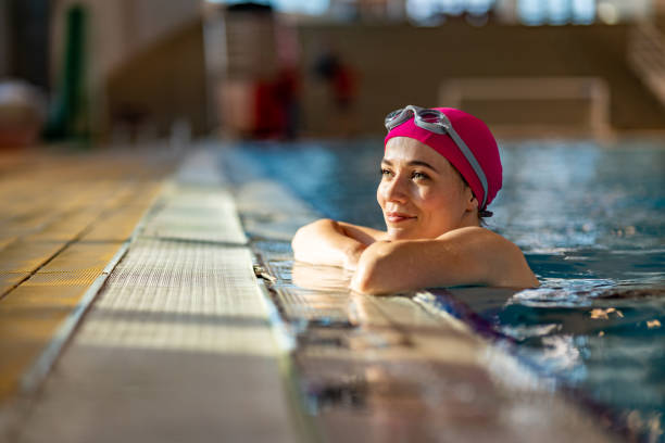 istock Smiling woman in swimming pool looking away while leaning. 1485093328