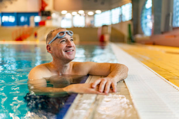 istock Mature man enjoying sunny day at the indoor pool 1485093416