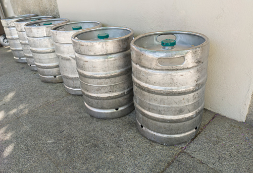 Beer kegs placed downtown street. Beverage distribution concept