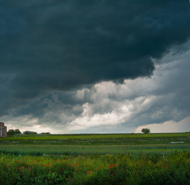 low storm clouds outside the city in the field