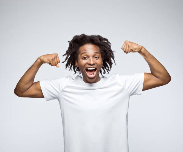 istock Potrait of happy man showing biceps 1485099144