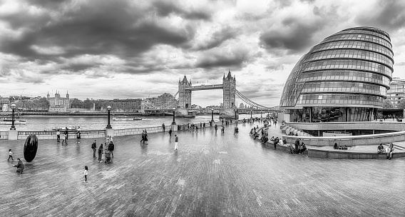 LONDON - APRIL 14, 2022: Scenic panoramic view of City Hall, Tower Bridge and Tower of London over the River Thames, some of the major landmarks in London, England, UK