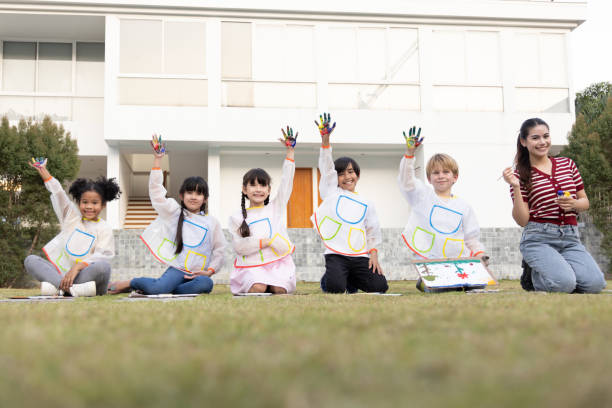 istock Happy children with painted hands, Elementary school student with draw coloring class concept 1485108003