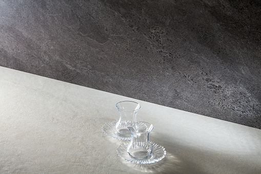 Two empty wine glasses on the background of marble tiles