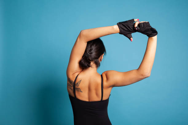 istock Back view of athletic trainer exercising gymnastic workout 1485110212