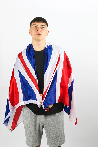 A portrait of a teenage boy with an Union Jack against a white background