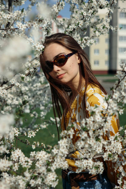 istock Young woman in garden with blooming trees in spring 1485111945