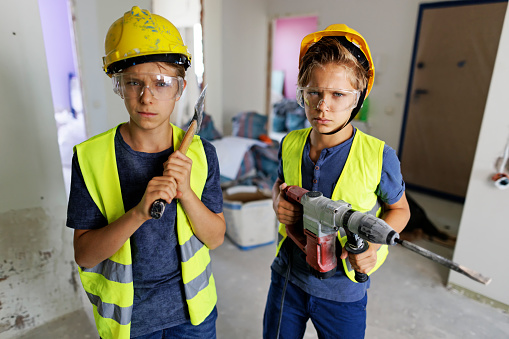 Fierce manual workers helping in renovating the room after the ruptured pipe has flooded the apartment. The boys holding a pneumatic hammer drill and an axe. They are ready to tear down water damaged plaster from the walls. And the walls.
Show with Canon R5