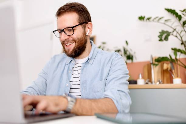 istock Man following online courses on laptop at home 1485113092