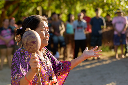 Peruíbe, SP, Brazil - April 21, 2023:  Shaman singing a blessing in the Guarani village of Tapirema
