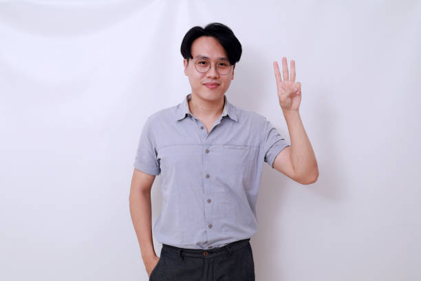 istock Happy Asian man standing while showing three fingers. Isolated on white background 1485119343