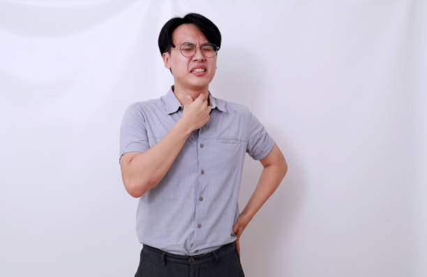 istock Sad sick young asian man with sore throat. Isolated on white background 1485119505