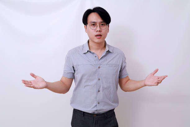 istock Confused asian man standing with asking hand gesture. Isolated on white 1485119754