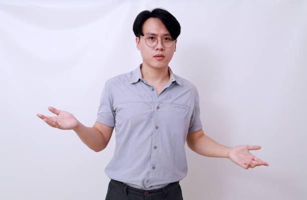 istock Confused asian man standing with asking hand gesture. Isolated on white 1485119870