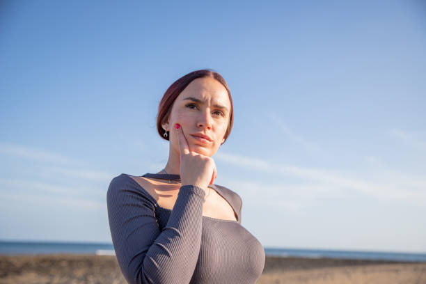 istock A young woman with a thoughtful expression at the beach, copy space on the right 1485120023