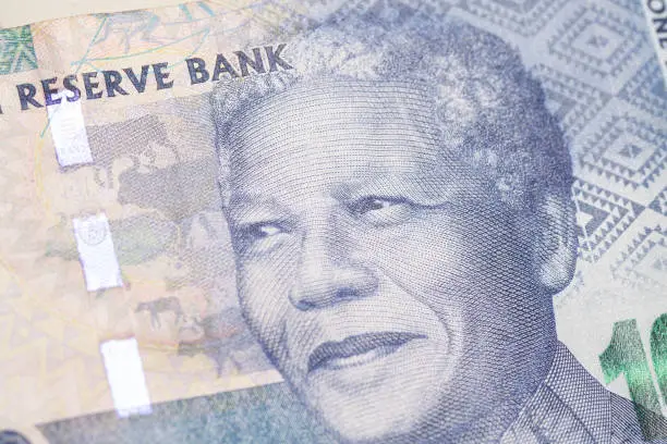 Nelson Holilala Mandela faces on South African money 100 rand banknotes macro. President of South Africa