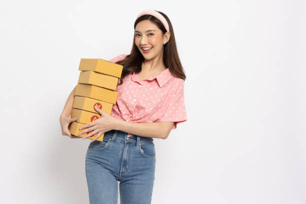 istock Asian female holding package parcel box isolated on white background, Delivery courier and shipping service concept 1485121491
