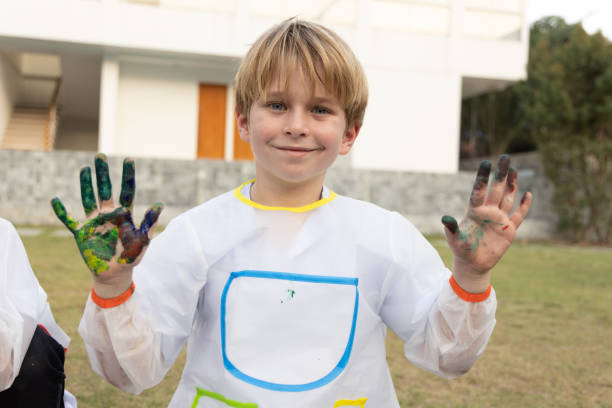istock Happy boy with painted hands and looking camera, Elementary school student with draw coloring class concept 1485121798