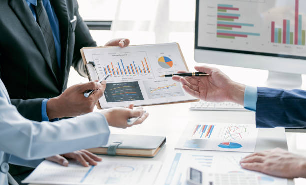 istock Group of young people working together. Creative business people analyzing business growth graph in modern office 1485122106