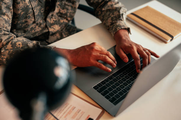 istock Soldier typing on laptop in office. 1485123003