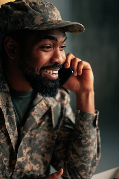 istock Cheerful soldier speaking on cellphone. 1485123020