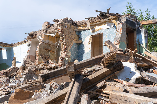 An abandoned house collapses. The house is destroyed. Cracks in wall of house. Destruction of old houses, earthquakes, economic crisis, abandoned houses. Broken unfit house