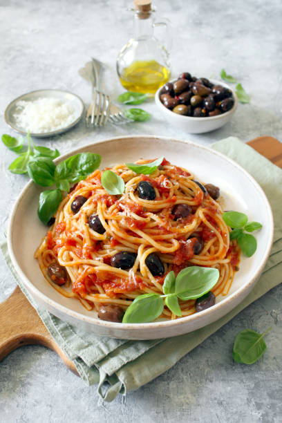 istock Pasta with tomato sauce, dark olive and parmesan cheese on light background. 1485123878