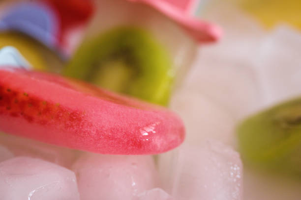 Popsicle with ice cubes in ceramic bowl,  cold refreshment, close up