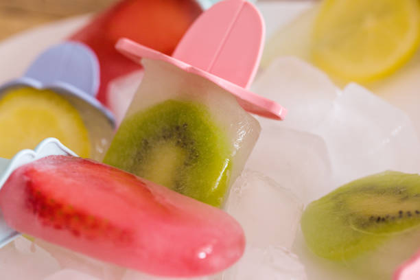 Popsicle with ice cubes in ceramic bowl,  cold refreshment, close up