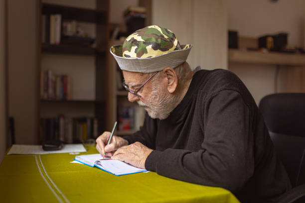 istock Senior Man With Alzheimer’s Writing Journal 1485131172