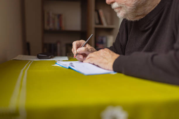 istock Senior Man With Alzheimer’s Writing in a Notebook 1485131245