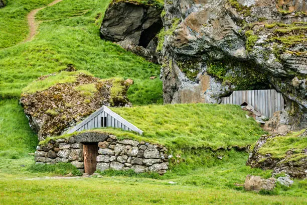 Photo of Rutshellir Caves turf cottage with grass roof the ancient habitations in the rock mountain at Iceland