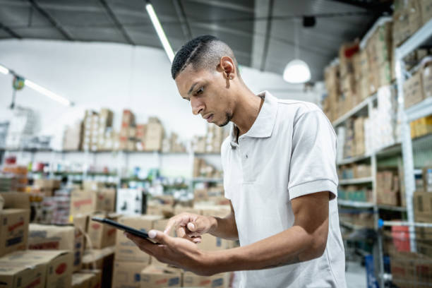 istock Young man working on a digital tablet at the supermarket 1485133510