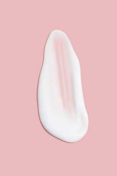 istock A dab of cosmetic cream. Light, smooth surface. Texture of spreadable cream. Liquid cream smear. On a pink background. 1485133542